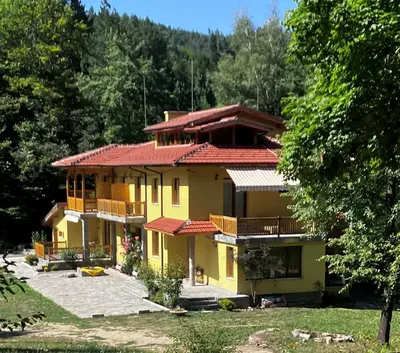 a large yellow house with a red roof at Вила Ренесанс Костенец in Kostenets Village