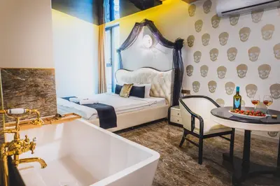 a bathroom with a tub and a bedroom with a bed at HIDDEN BANK: First Million in Plovdiv