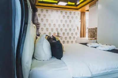 a bedroom with a bed with white sheets and pillows at HIDDEN BANK: First Million in Plovdiv