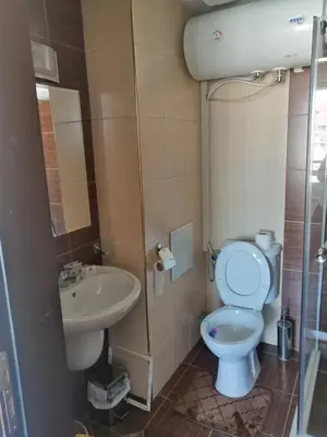 a bathroom with a toilet and a sink at Bansko Royal Towers T&K in Bansko