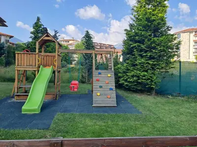a playground with a climbing frame and a slide at Bansko Royal Towers T&K in Bansko