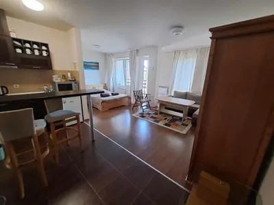a kitchen and living room with a table and chairs at Bansko Royal Towers T&K in Bansko