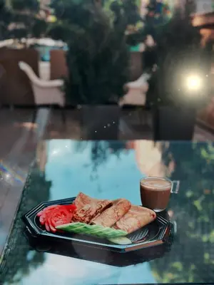 a plate of food on a glass table with a drink at HIDDEN BANK: Cash in Plovdiv