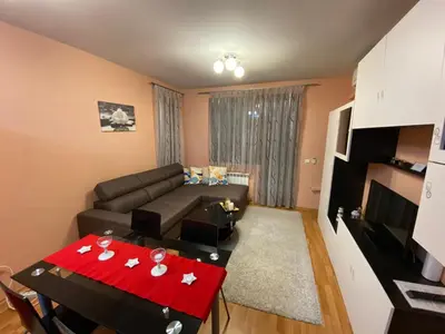 a living room with a couch and a table at Mia's Apartment, Stylish one-bedroom apartment in Sofia