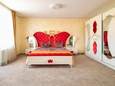 a bedroom with a bed with a red headboard at Айляк Клуб Велинград - Бутиков Хотел&СПА с Elegant Ultra All Inclusive in Velingrad