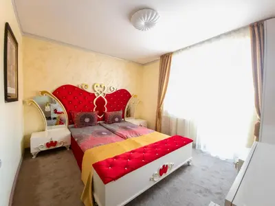 a bedroom with a red bed with a red headboard at Айляк Клуб Велинград - Бутиков Хотел&СПА с Elegant Ultra All Inclusive in Velingrad