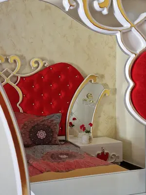 a bedroom with a red and white bed with a mirror at Айляк Клуб Велинград - Бутиков Хотел&СПА с Elegant Ultra All Inclusive in Velingrad
