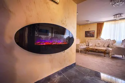 a living room with a fireplace in the wall at Айляк Клуб Велинград - Бутиков Хотел&СПА с Elegant Ultra All Inclusive in Velingrad