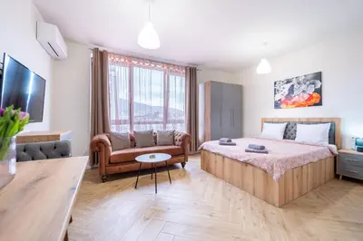 a bedroom with a bed and a couch and a chair at WOW studios for rent - bul Montevideo 25A - B in Sofia