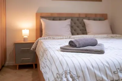 a bed with two towels sitting on top of it at WOW studios for rent - bul Montevideo 25A - B in Sofia