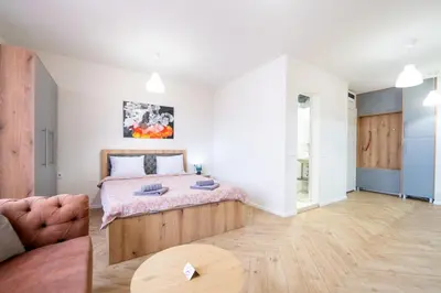 a bedroom with a bed and a couch and a table at WOW studios for rent - bul Montevideo 25A - B in Sofia