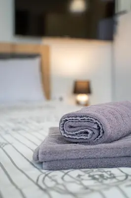 a purple towel sitting on top of a bed at WOW studios for rent - bul Montevideo 25A - B in Sofia
