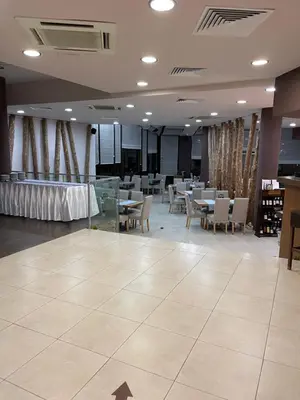 a restaurant with tables and chairs in a room at Pirin Dream View Apartments in Razlog