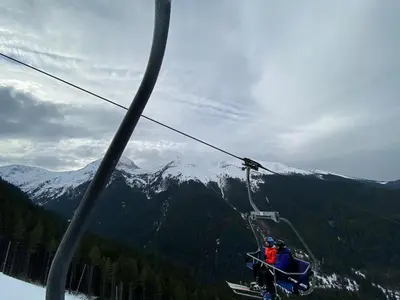 a group of people riding on a ski lift at CEDAR LODGE NEXT TO LIFT ONE BEDROOM APARTMENT in Bansko