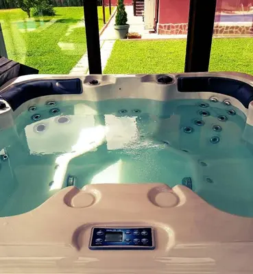 a jacuzzi tub with blue water in front of a window at Casa Veneta in Oreshak