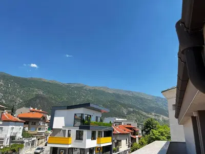 a view of a city with mountains in the background at Hotel Central in Karlovo