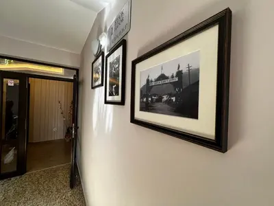 a hallway with three framed pictures on a wall at Hotel Central in Karlovo