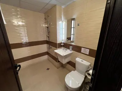 a bathroom with a toilet and a sink at Hotel Central in Karlovo