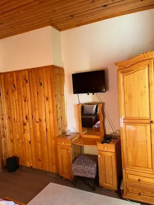 a room with a desk with a computer and a tv at Orehite Guest House in Samokov