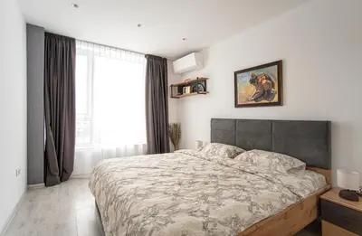 a bedroom with a large bed and a window at Sunny & Stylish Brand new 2bdr Apartment + Parking in Sofia