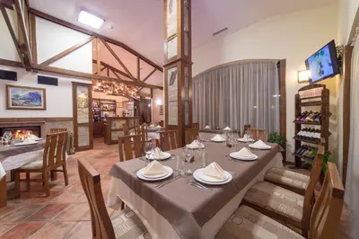 a dining room with a table and chairs at Smolyan Lakes Apartment / Апартамент Смолянски езера in Smolyan