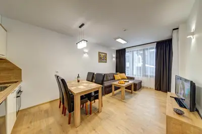 a living room with a table and a couch at Smolyan Lakes Apartment / Апартамент Смолянски езера in Smolyan