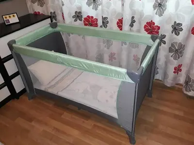 a baby crib with a green and white canopy at Sunflower Apartment City Center in Plovdiv