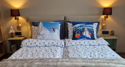 a bed with a bunch of pillows on it at PinePino Borovets, aparthotel Borovets Gardens A60 in Borovets