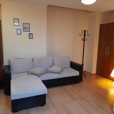 a living room with a couch with pillows on it at Studio Villa Park 410 in Borovets