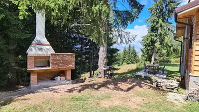 a brick oven in a yard next to a house at Villa Mischa in Grashtitsa