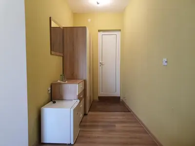 a small kitchen with a refrigerator and a door at Дамяновата къща in Sapareva Banya