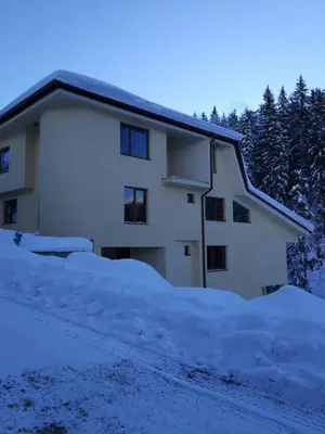 a house with a lot of snow in front of it at Вила ОБЗОР in Progled