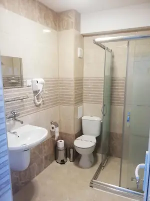 a bathroom with a toilet and a sink and a shower at Вила ОБЗОР in Progled