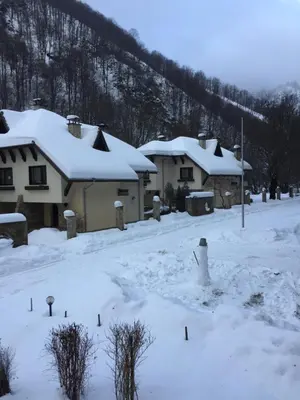 a group of houses with snow on the roofs at Балкан вили in Ribarica
