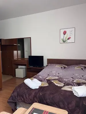 a bedroom with a bed with two towels on it at Kalina Apartment's in Bansko in Bansko