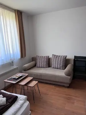 a living room with a couch and a table at Kalina Apartment's in Bansko in Bansko