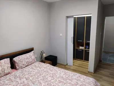 a bedroom with a bed with a pink bedspread at Apartment Anelia 1 in Plovdiv