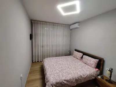 a small bedroom with a bed and a window at Apartment Anelia 1 in Plovdiv