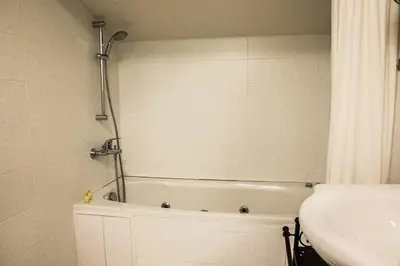 a bathroom with a bath tub and a sink at RILA 6ATO Hotel & Restaurant in Panichishte