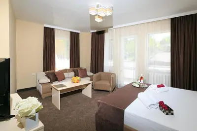 a hotel room with a bed and a couch at HOTEL THE WHITE HOUSE Plovdiv in Plovdiv