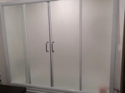 a white cabinet with glass doors in a room at Grand Bansko D104 APARTMENT in Bansko