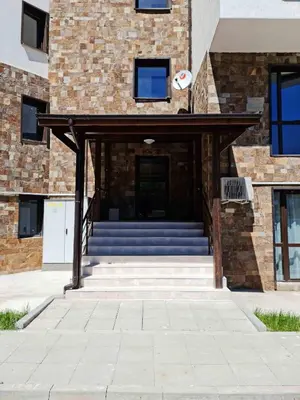 an entrance to a building with stairs and a door at Grand Bansko D104 APARTMENT in Bansko