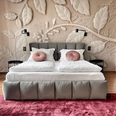 a bedroom with a large bed with white sheets and pink pillows at ATRIUM Boutique Suites Sofia in Sofia