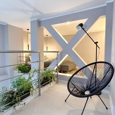 a chair on a balcony with plants at ATRIUM Boutique Suites Sofia in Sofia