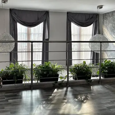 a room with potted plants and large windows at ATRIUM Boutique Suites Sofia in Sofia
