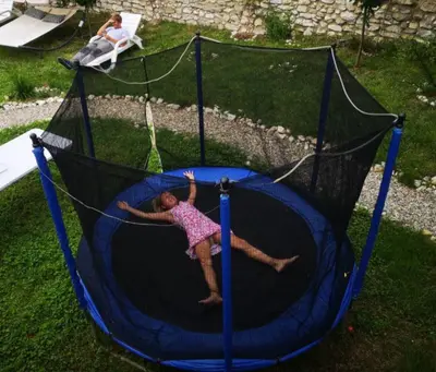 a young girl is playing on a trampoline at VillaPo in Ilindentsi