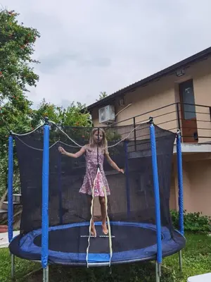 a little girl standing on a trampoline at VillaPo in Ilindentsi