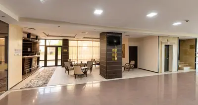 a dining room with a table and chairs in a building at Хотел България Петрич in Petrich