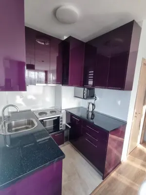 a kitchen with purple cabinets and a sink at Mountain view apartment in Sofia