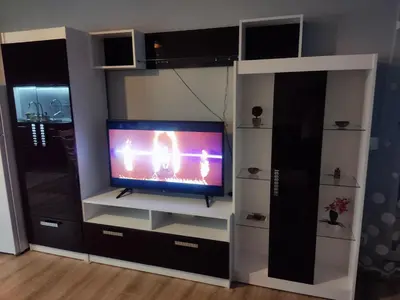 a living room with a tv in a entertainment center at Mountain view apartment in Sofia